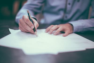 Business owner comparing financial documents and invoice statements on a desk