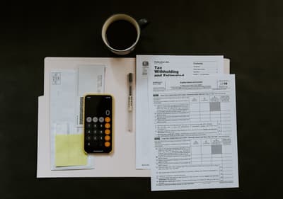 Business owner planning loan repayment strategy with financial reports and calendar